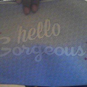 A makeup bag that says " ✨Hello Gorgeous ✨"